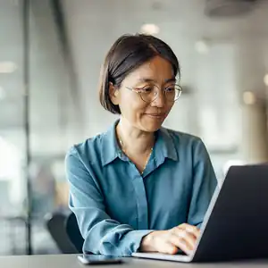 A woman using her laptop to create a MyFTB account.